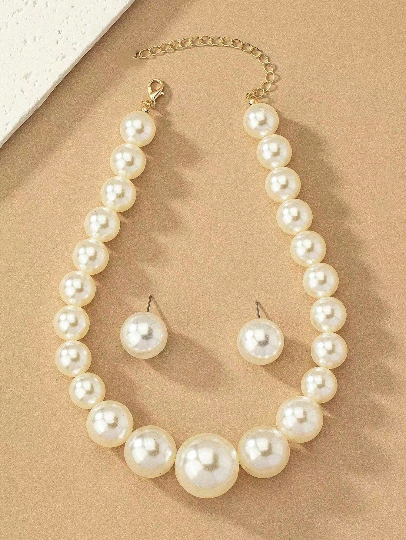 Exaggerated and trendy faux pearl earrings and faux pearl necklace