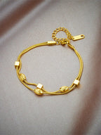 Double layer woven studded chain bracelet in gold plated stainless steel with screw-in fastening